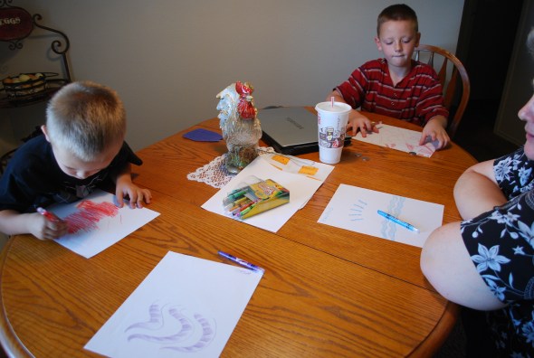 The work of "Creative Simplicity Itself" begins. Each has a piece of paper and a crayon color. The timer is set and off we go!